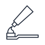 A simplistic outline rendering of a tube of toothpaste distributing onto a toothbrush.